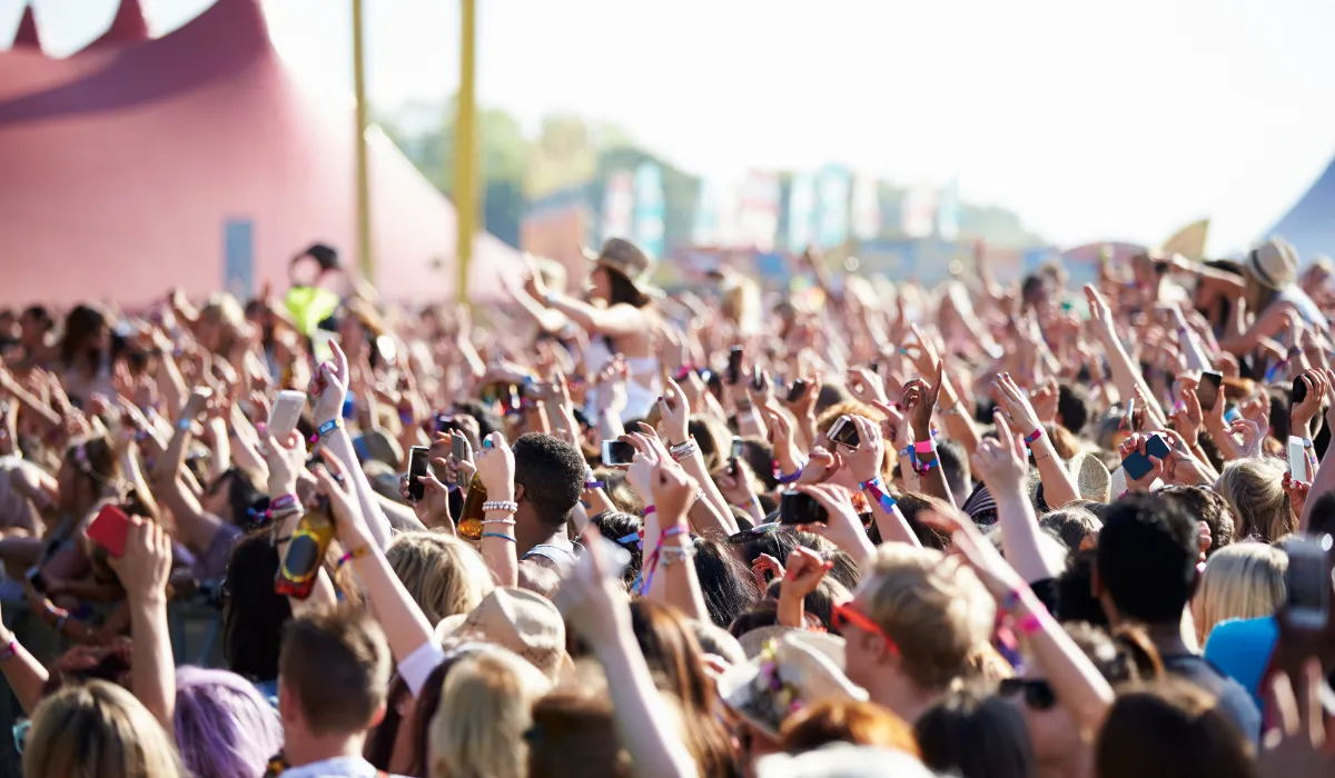 Festival crowd with raised hands in the sun